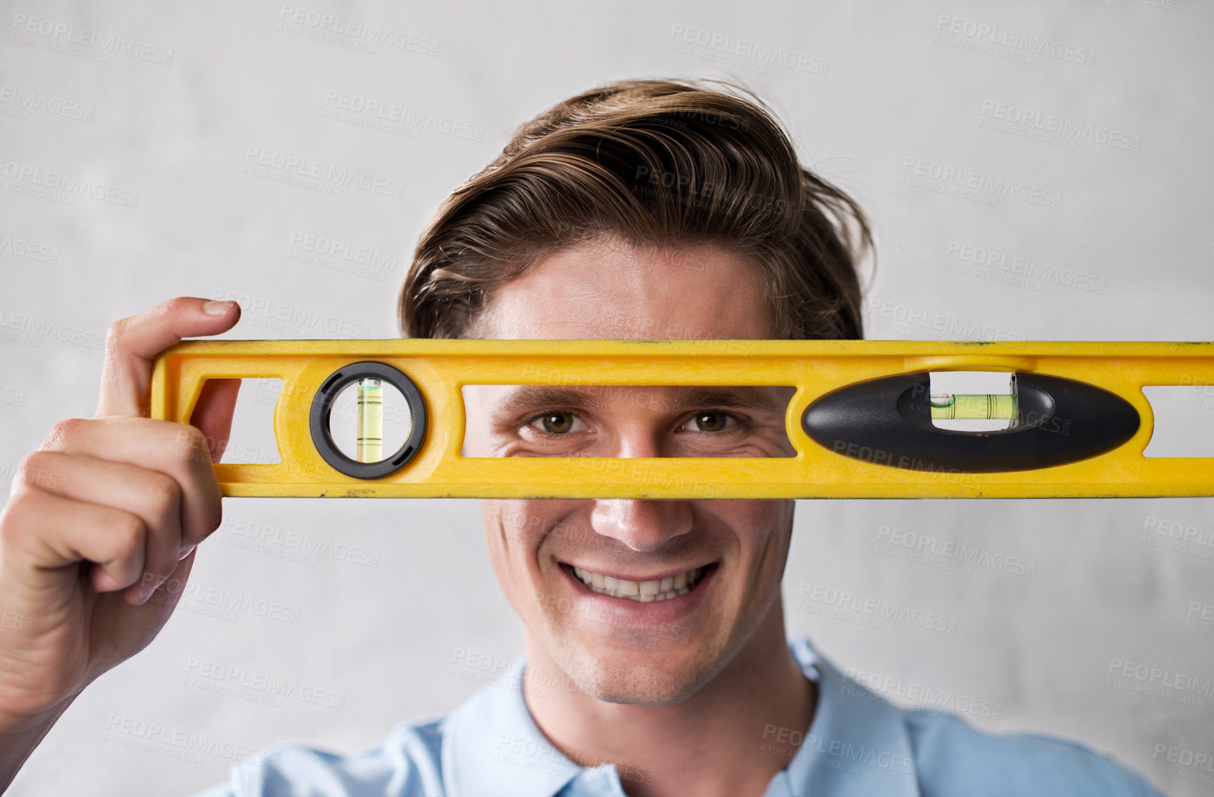 Buy stock photo A handsome young man holding up a work tool