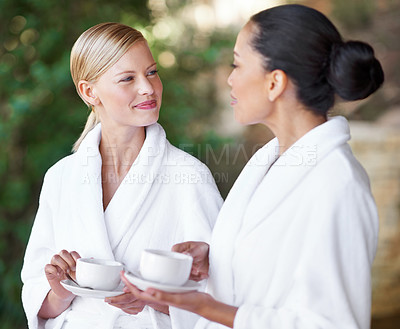 Buy stock photo Spa, friends or women drinking coffee in nature together for health, wellness or skincare treatment. Girls, tea cup or salon for beauty, luxury body therapy in bathrobe or diverse people talk outdoor