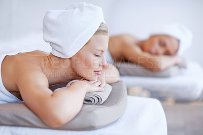 Buy stock photo Women, spa and relax lying on table for skincare, beauty and luxury treatment for wellness. People, rest and calm person on bed in salon or hotel for massage or dermatology care with zen or peace