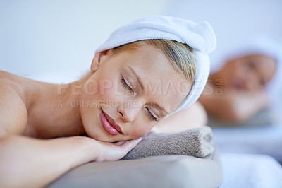 Buy stock photo Woman, relax and lying on table in spa with peace for skincare, beauty and luxury treatment for wellness. People, rest and face of calm person on bed in hotel for massage or dermatology care for body