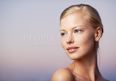 Buy stock photo A beautiful young model glancing over her shoulder against a soft purple background