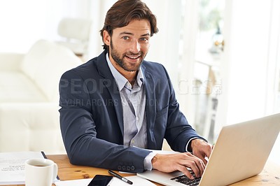 Buy stock photo An attractive businessman working on his laptop
