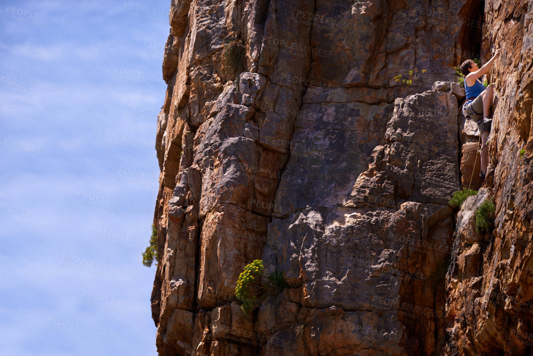 Buy stock photo Woman, rock climbing and outdoors for adventure, fitness and exercise in the sun for extreme sports. Female person, climb wall and nature for wellness, mountain and fearless activity for strength 