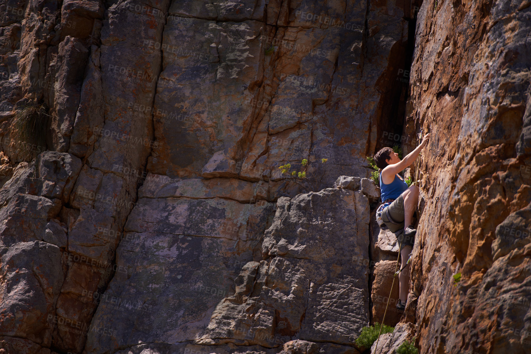 Buy stock photo Woman, mountain climbing and outdoors for adventure, fitness and exercise in the sun for extreme sports. Female person, rock workout and nature for wellness, risk and fearless activity for strength 