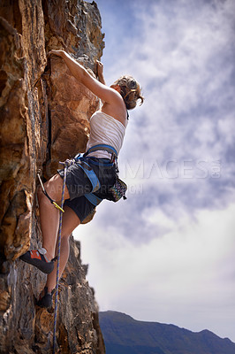 Buy stock photo Woman, grip and rock climbing for fitness in outdoors, challenge and rope for training. Female person, cliff and extreme sport for exercise or workout, adventure and support to explore in nature