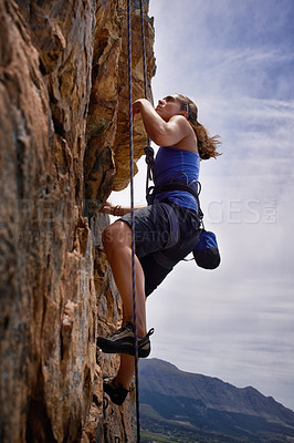 Buy stock photo Woman, hiking and rock climbing for workout in outdoors, challenge and rope for training. Female person, cliff and extreme sport for exercise or fitness, mountain and support to explore in nature