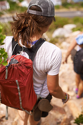 Buy stock photo Woman, hiking and backpack on mountain for fitness, adventure or rocky trail of outdoor path in nature. Rear view of female person or hiker walking down cliff in extreme trekking or adventure outside