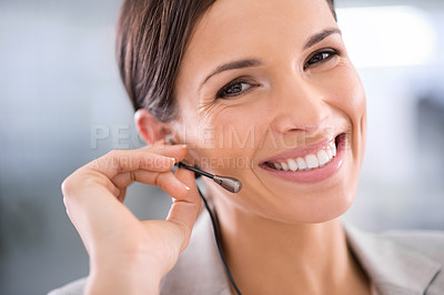 Buy stock photo Happy and smiling woman wearing a headset working in a call centre portrait. Young, beautiful and confident professional female customer service agent talking and answering calls during a work day.