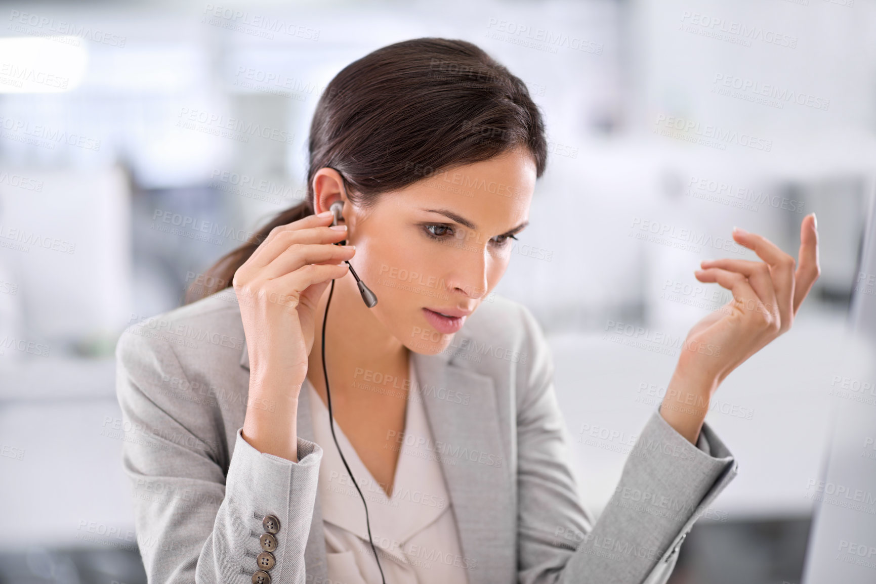 Buy stock photo Call center agent helping a client via phone call to give them good customer service and care. Professional consultant employee at contact support listening to a person via her headset at work desk