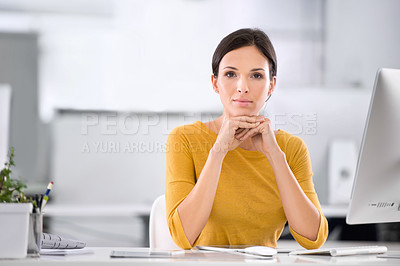 Buy stock photo Serious, confident and ambitious business woman sitting at her desk while resting her chin on her hands. Portrait of a female entrepreneur showing great leadership skills while working in an office 
