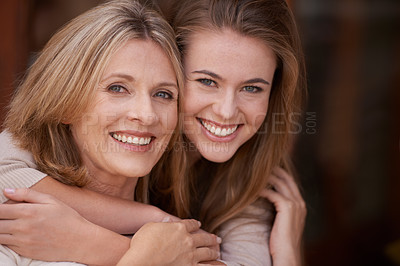 Buy stock photo A mother and daughter embracing each other