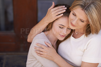 Buy stock photo A mother lovingly embracing her adult daughter