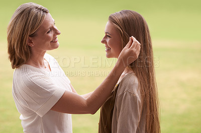 Buy stock photo Happy, mother and daughter touching hair for love, care and proud family for support. Woman, smiling and outdoors for healthy relationship, parent and mom with teenage daughter in nature park