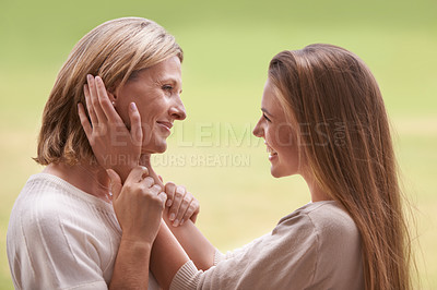 Buy stock photo Women, mother and daughter with embrace, love and mature person with connection, happy and care. Mom, girl and family with bonding, reunion and support with relationship, smile and together by grass