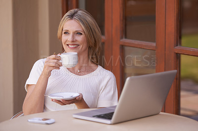 Buy stock photo Happy, mature woman and thinking with coffee or laptop on table for morning, remote work or drink at home. Female person or freelancer smile with beverage or cup of tea by computer for networking