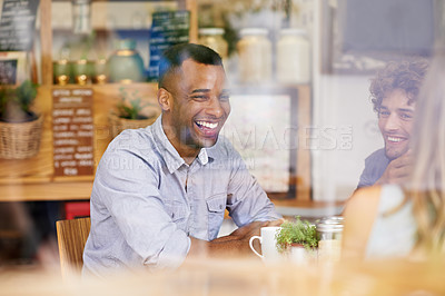 Buy stock photo Shot of a group of friends hanging out in a coffee shop