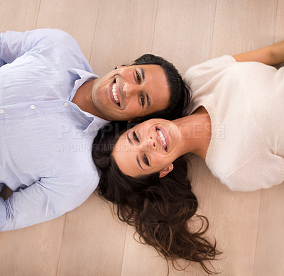 Buy stock photo Portrait, happy and top view of couple on floor, relax and  bonding together in home. Above, man and face of woman with a smile for connection, love and commitment for healthy relationship in house