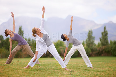 Buy stock photo Group, women and yoga in warrior pose outdoor for healthy body, exercise or fitness of friends. Park, virabhadrasana and people in nature for balance, stretching and holistic practice for wellness