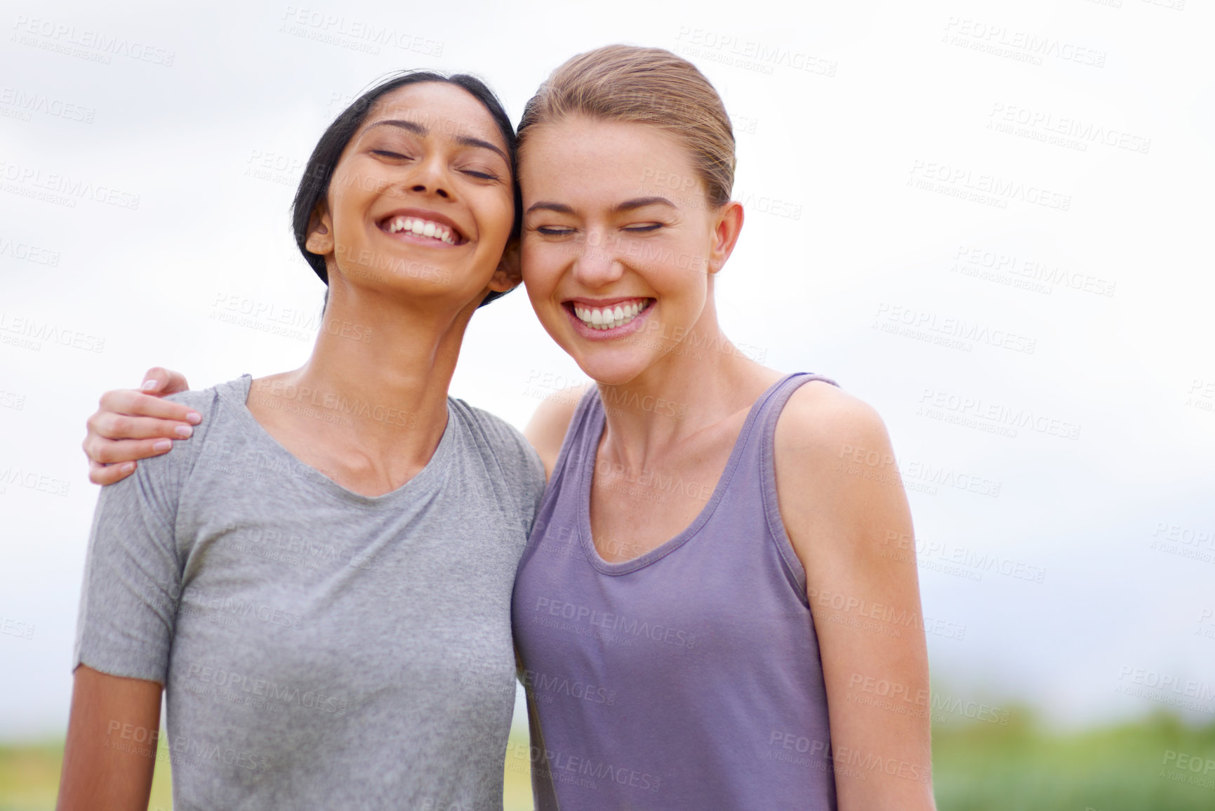 Buy stock photo Two young ladies laughing with each other