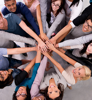 Buy stock photo High angle shot of a group of businesspeople with their hands in a huddle
