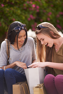 Buy stock photo Two young ladies admiring their shopping finds