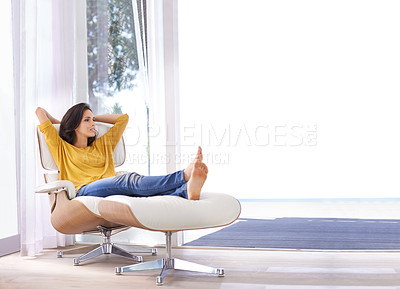 Buy stock photo An attractive woman relaxing on a chair with her hands behind her head