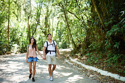 Buy stock photo Hiking, walking and couple holding hands in forest for adventure, freedom and relax outdoors. Love, travel and man and woman on trail for holiday, vacation and trekking for wellness and fitness