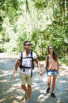Buy stock photo Walking, hiking and couple holding hands in nature for adventure, freedom and backpacking outdoors. Travel, bonding and man and woman on trail for holiday, vacation or trekking for wellness in forest