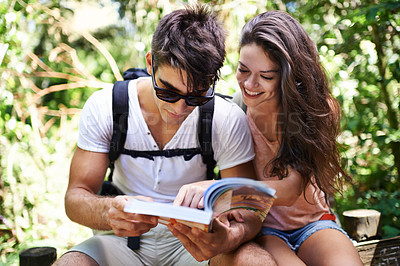 Buy stock photo Couple, map and backpack for hiking in jungle with reading for thinking, holiday or search by trees. Man, woman and bag for trekking, direction or journey in forest with book for location in Colombia