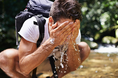 Buy stock photo Water, splash or man hiking in forest or wilderness for cleaning face or trekking adventure. River, relax or male hiker on break walking in a natural park or nature for exercise or wellness by a lake