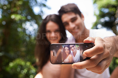 Buy stock photo Couple, selfie and phone screen for hiking in forest with smile for memory, post and web blog. Man, woman and profile picture for trekking, direction and jungle on app for social media in Colombia