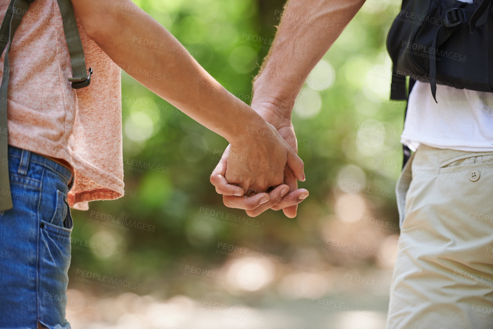 Buy stock photo Couple, holding hands and support with love in nature for bonding, walk or hiking adventure together. Closeup of man and woman in unity, trust or teamwork for trekking in outdoor woods or forest