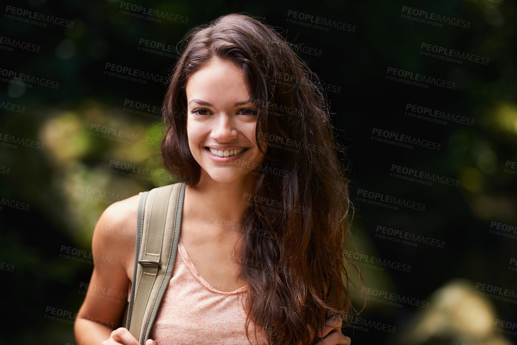Buy stock photo Walking, travel or happy woman in nature, woods or wilderness for trekking or outdoor adventure with bag. Smile, relax or hiker hiking in natural park or forest for exercise or wellness on holiday