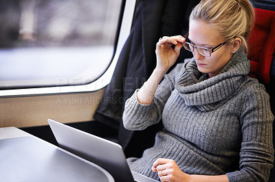 Buy stock photo Woman, freelancer and laptop with work on train for trip, commute or journey on business travel. Female person, writer and technology with thinking for ideas, research or reading blog online