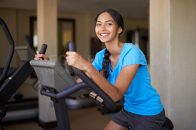 Buy stock photo Woman, portrait and workout bike in gym, cycling and stationary machine for exercise or training. Happy female person, cardio and cycling for wellness, smile and equipment for fitness and health