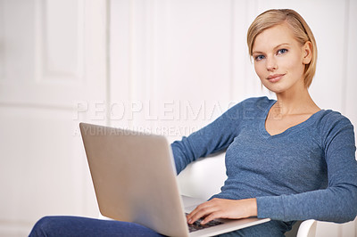 Buy stock photo Portrait of a beautiful woman sitting on a chair using a laptop