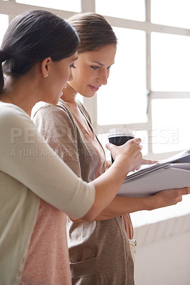 Buy stock photo Woman, paper and coffee in office with collaboration for teamwork, discussion and planning at workplace. Professional people, employees and document with explaining for help, partnership and ideas