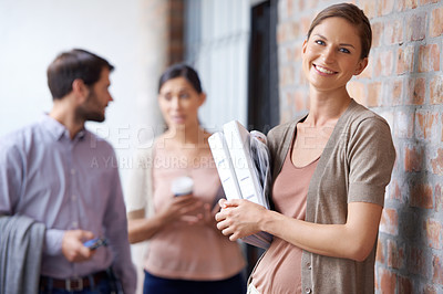 Buy stock photo Shot of  three young colleagues in their office building