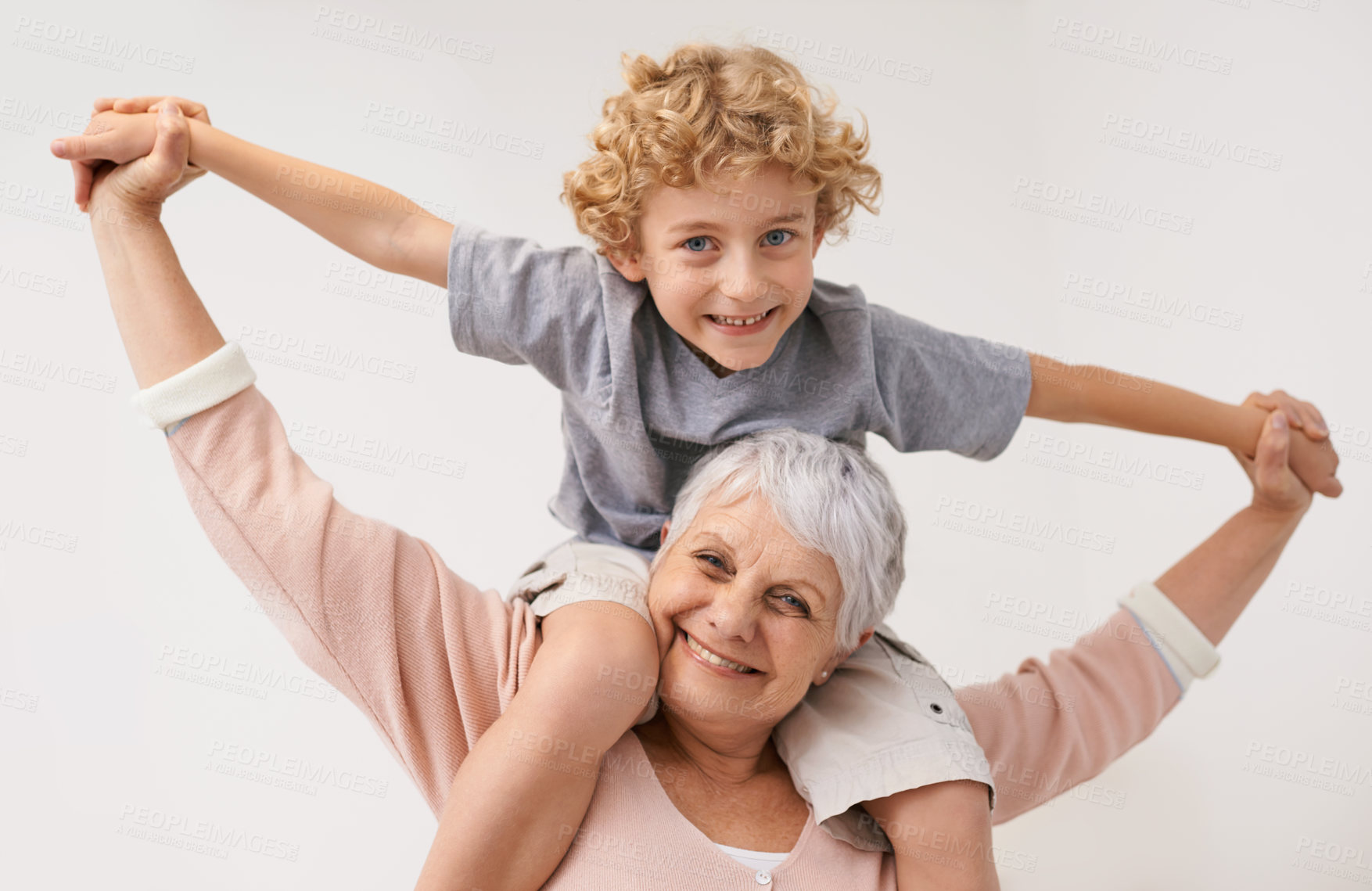 Buy stock photo Portrait, airplane and grandmother with child embrace, happy and bonding against wall background. Love, face and senior woman with grandchild having fun playing, piggyback and enjoying game together