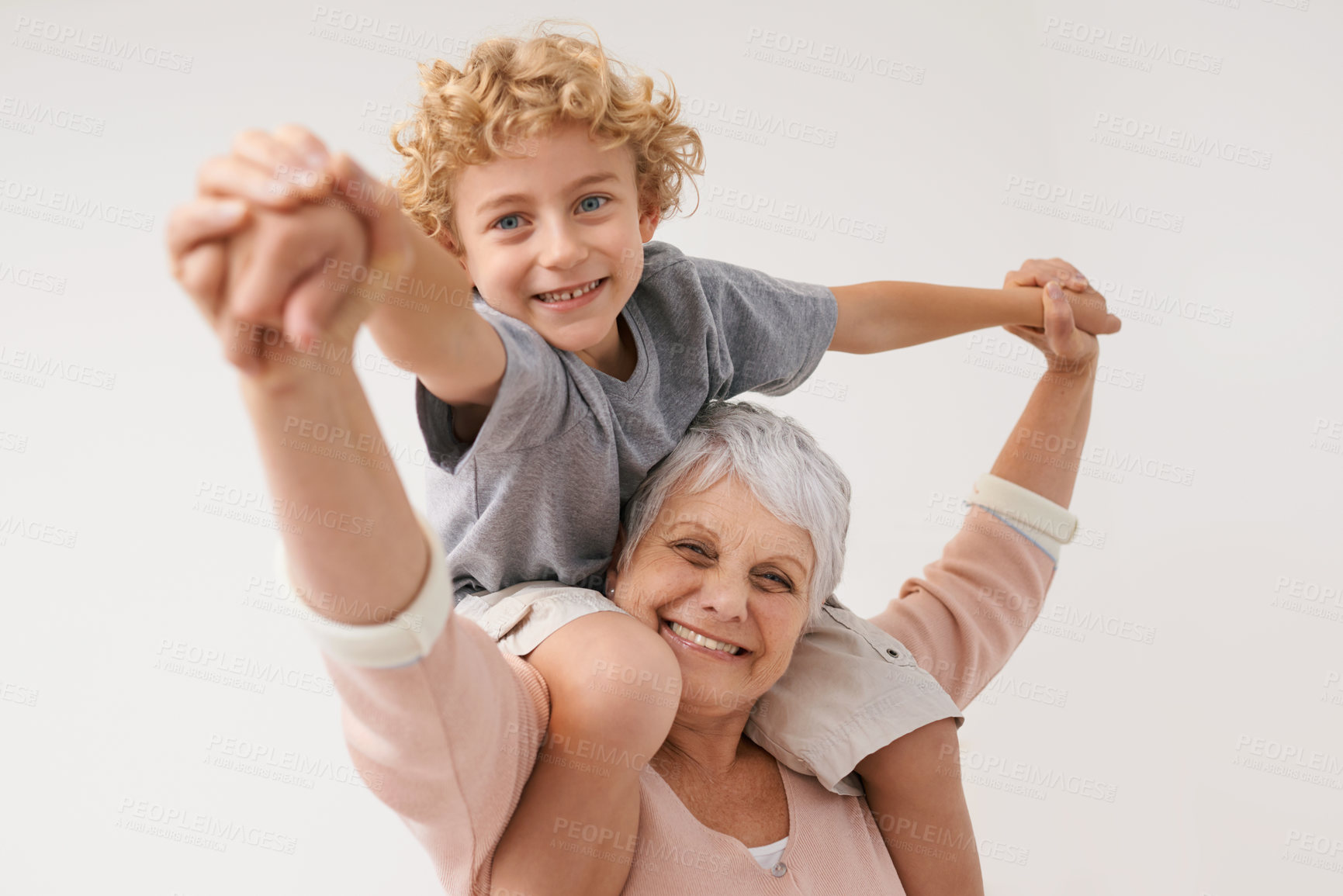 Buy stock photo Airplane, portrait and grandmother with child embrace, happy and bonding against wall background. Love, face and senior woman with grandchild having fun playing, piggyback and enjoying game together