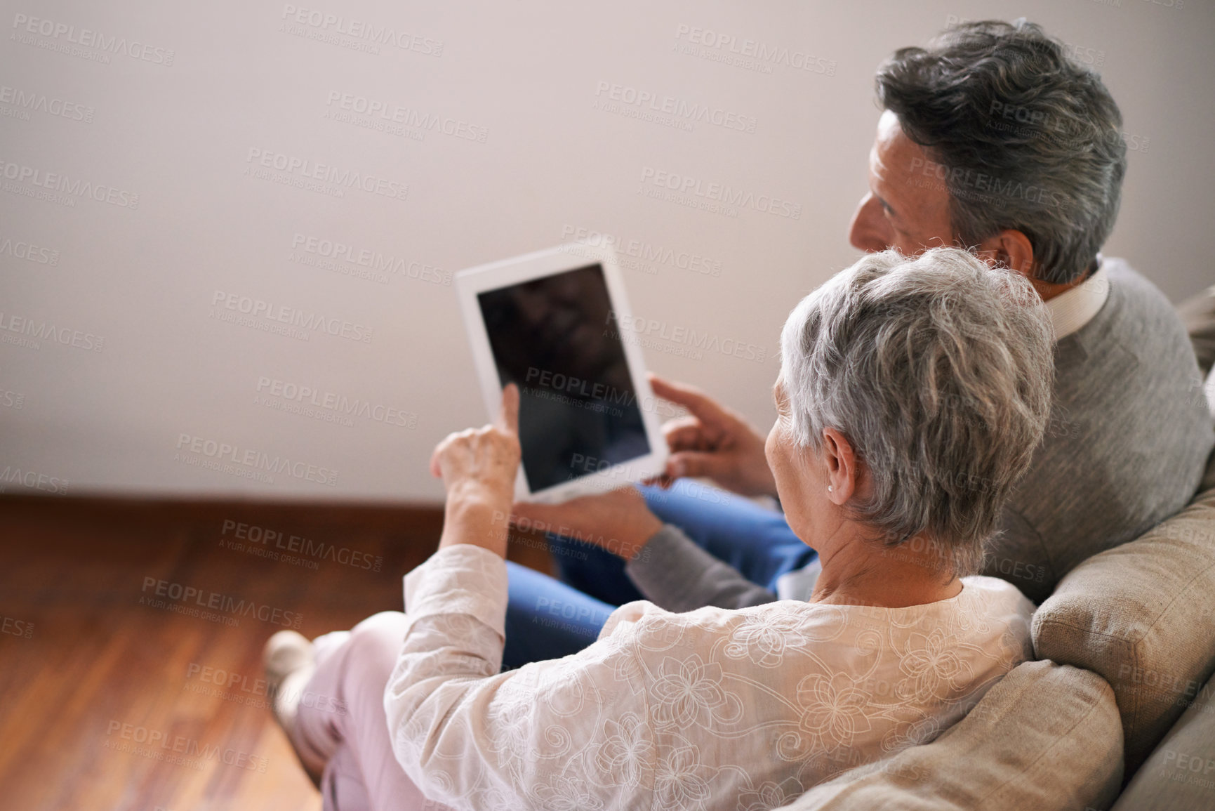 Buy stock photo Tablet, mockup or old couple streaming movie or film on online subscription in retirement at home together. Screen, relaxing or back of senior woman loves watching fun videos with an elderly man