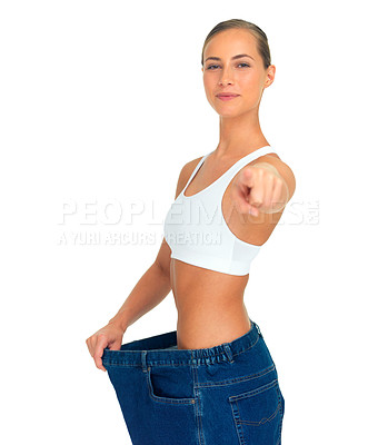 Buy stock photo Health, weight loss and woman pointing hand with jeans and tummy tuck with skinny waist, isolated on white background. Smile, healthcare and wellness, happy girl with liposuction, diet and big pants.