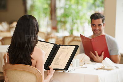 Buy stock photo Couple, restaurant and menu for food choice, fine dining and bonding on valentines day. People, love and romance at cafe or lunch selection for anniversary date, gourmet cuisine and happy at bistro