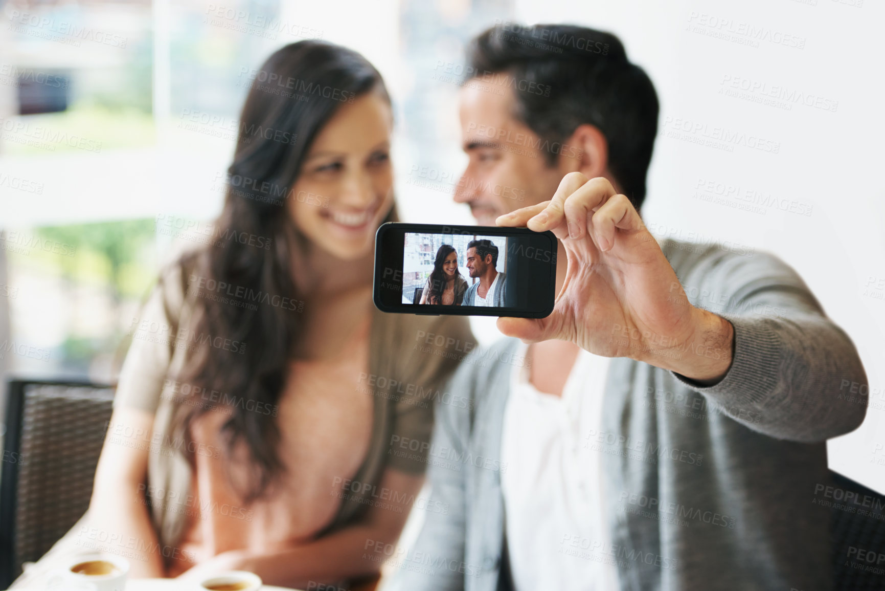 Buy stock photo Happy couple, selfie or love in coffee shop on vacation or post on social media of romantic date together. Man, woman or care in marriage in profile picture or connection on cellphone in restaurant