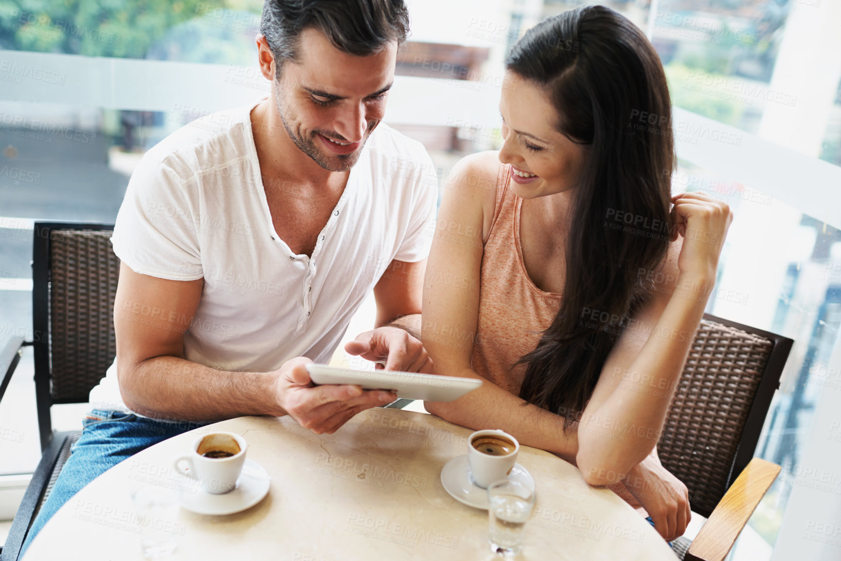 Buy stock photo Happy couple, love and tablet in coffee shop to relax and bonding together on espresso date on social media. Man, woman and technology for surfing internet for meme and connection with care in above