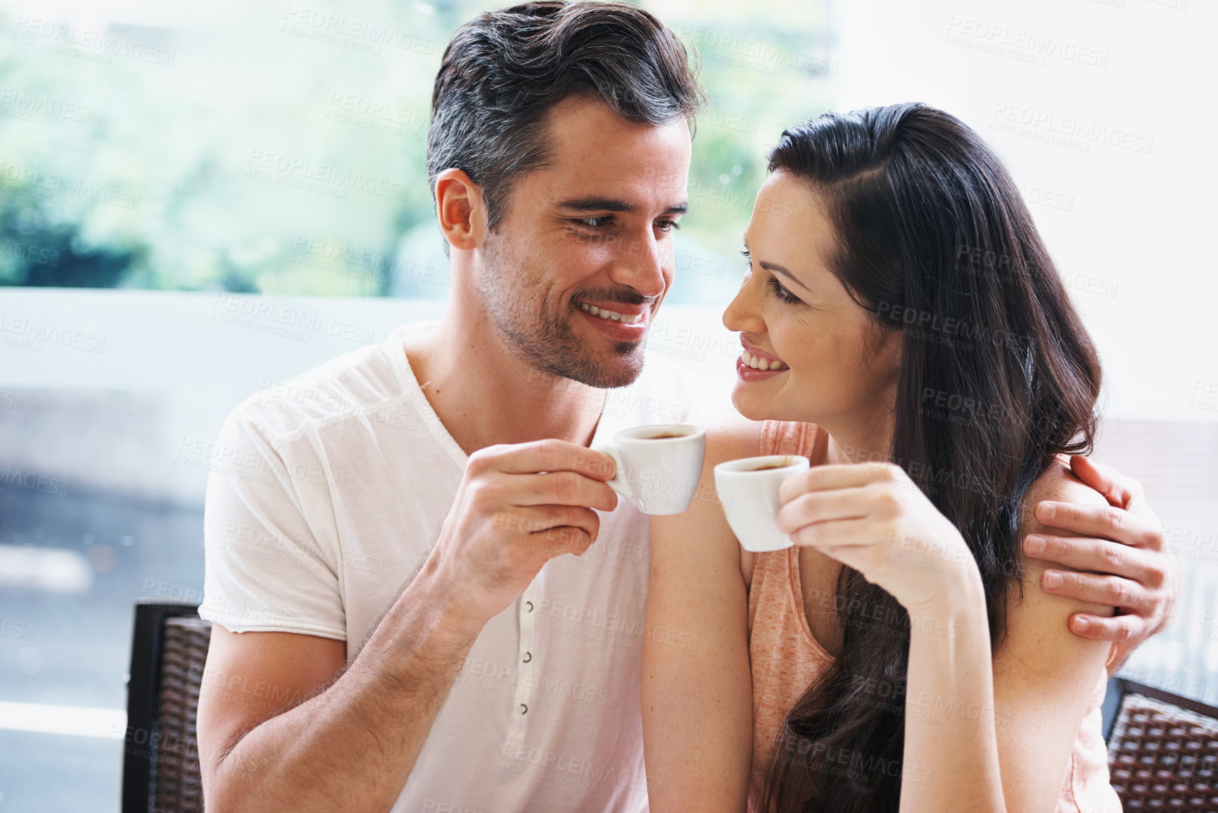 Buy stock photo Date, coffee and couple at cafe with relax, happy and love together with smile and hot drink at a table. Espresso, morning and marriage at a restaurant with bonding, care and romance by window
