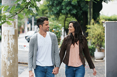 Buy stock photo Happy couple, walking and holding hands in city with love and bonding together on vacation in outdoor. Husband, wife and smile on face on romantic date, holiday and adventure in italy for honeymoon