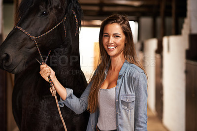 Buy stock photo Portrait of a young woman in a stable with her horse