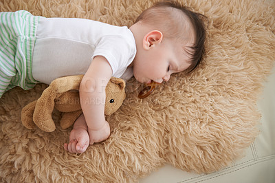 Buy stock photo Toddler, sleep and home with teddybear in sofa to rest, tired and relax with dummy and dream. High angle, baby,  and nap in couch for child development, growth and innocent with peace for bedtime.