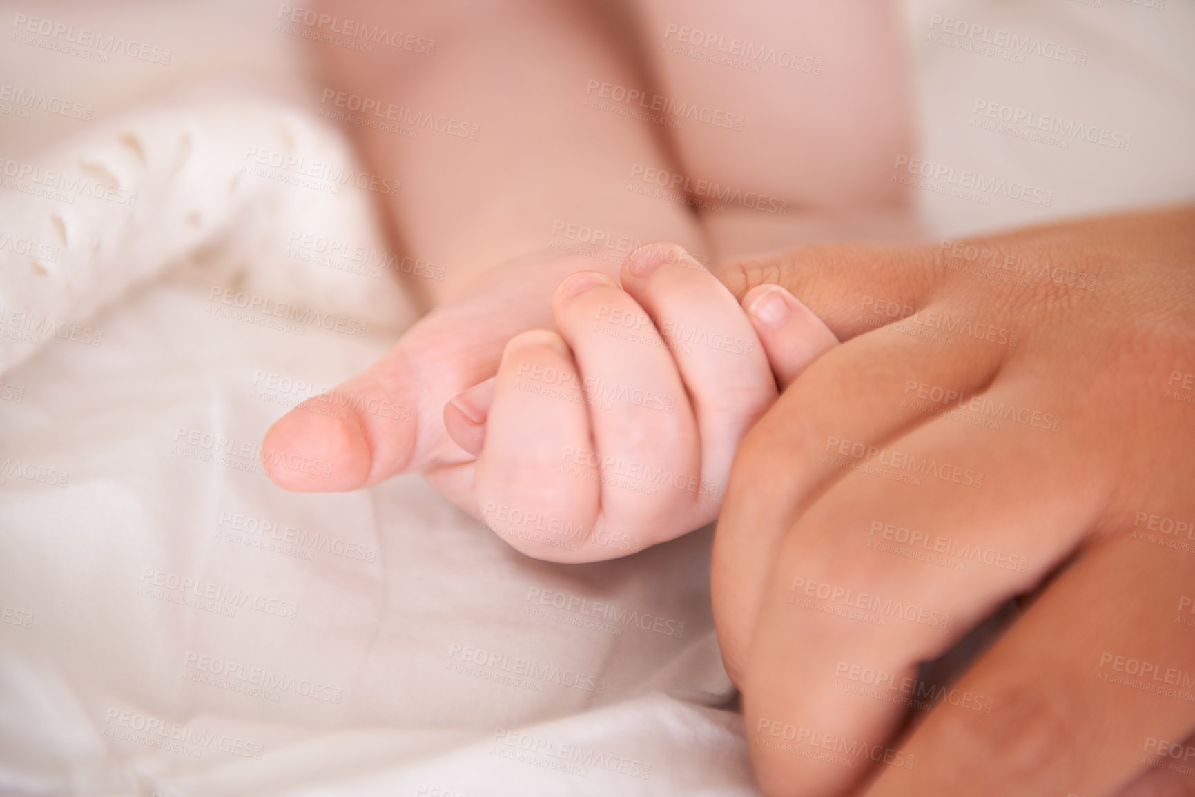 Buy stock photo Bed, holding hands and parent with infant, wellness and support with maternity, health and bonding at home. Fingers, family and love with baby, protection and childcare with love, closeup or relaxing